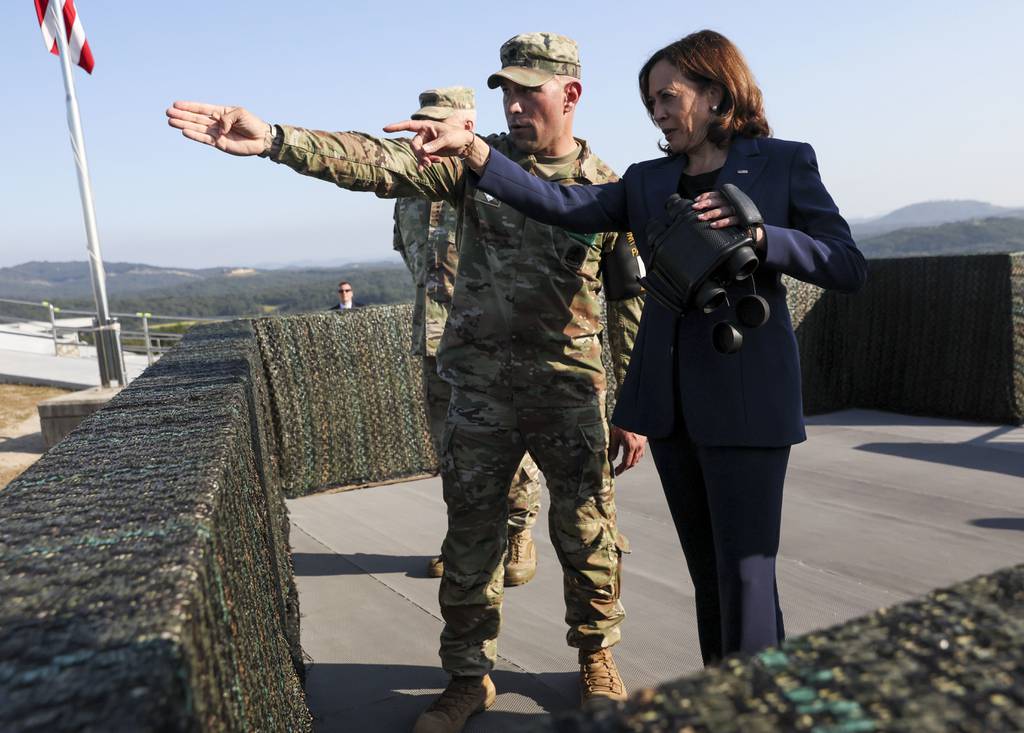 U.S. Vice President Kamala Harris, right, uses binoculars at the military observation post as she visits the demilitarized zone separating the two Koreas, in Panmunjom, South Korea Thursday, Sept. 29, 2022.