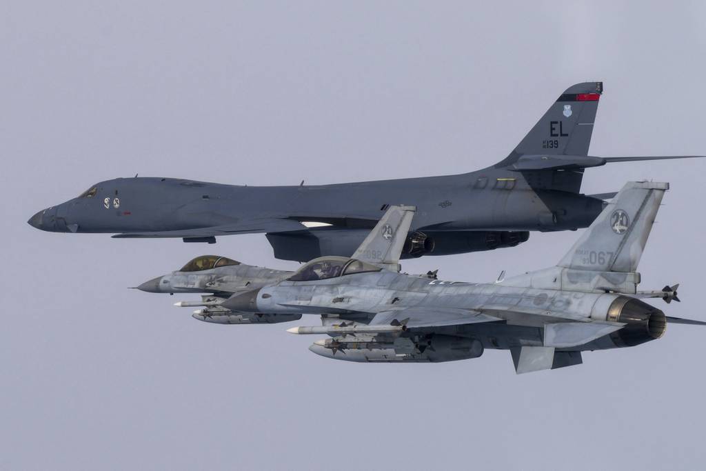 In this photo provided by South Korea Defense Ministry, a U.S. Air Force B-1B bomber, top, flies in formation with South Korea's Air Force KF-16 fighters over the South Korea Peninsula during a joint air drill in South Korea, Friday, March 3, 2023.