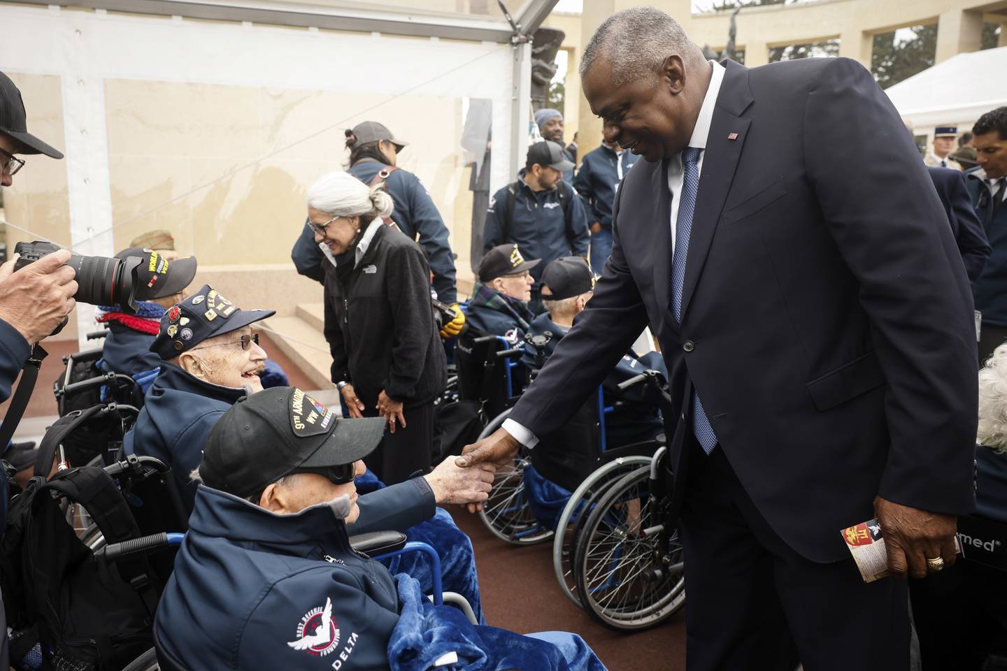 U.S. Defense Secretary Lloyd Austin, right, greet U.S war veterans during a ceremony to mark the 79th anniversary of the assault that led to the liberation of France and Western Europe from Nazi control, at the American Cemetery in Colleville-sur-Mer, Normandy, France, Tuesday, June 6, 2023.