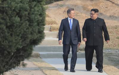 In this April 27, 2018, file photo, North Korean leader Kim Jong Un, right, and South Korean President Moon Jae-in stroll together at the border village of Panmunjom in the Demilitarized Zone, South Korea.