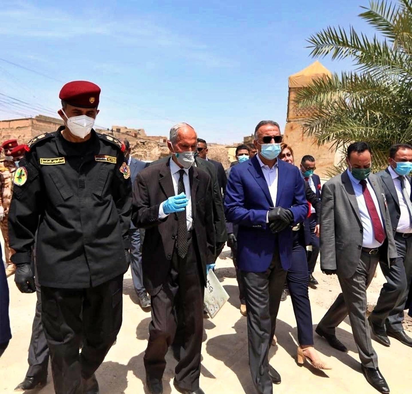 Iraqi Prime Minister Mustafa al-Kahdimi, center, visits the site of the Al–Nuri mosque, which was destroyed by Islamic State militants, during his visit to Mosul, Iraq, Wednesday, June 10, 2020.
