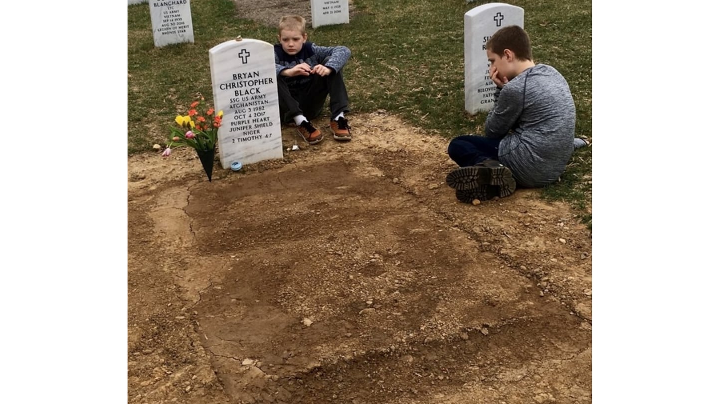 Bryan Black's sons Ezekiel and Isaac visit their father's grave.