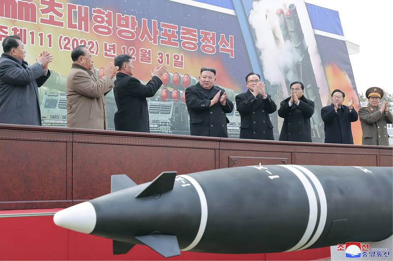 In this photo provided by the North Korean government, North Korean leader Kim Jong Un, center, attends a ceremony of donating 600mm super-large multiple launch rocket system at a garden of the Workers' Party of Korea headquarters in Pyongyang, North Korea Saturday, Dec. 31, 2022.