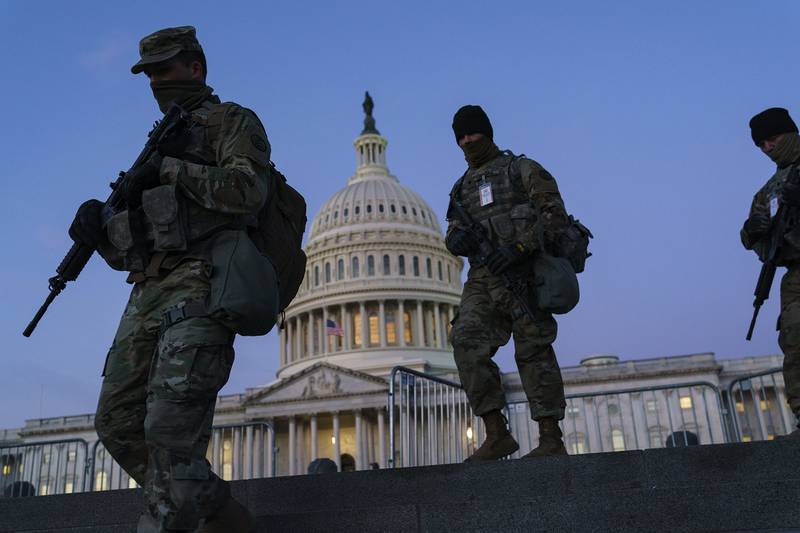 National Guard troops reinforce the security zone on Capitol Hill in Washington, Tuesday, Jan. 19, 2021, before President-elect Joe Biden is sworn in as the 46th president on Wednesday.