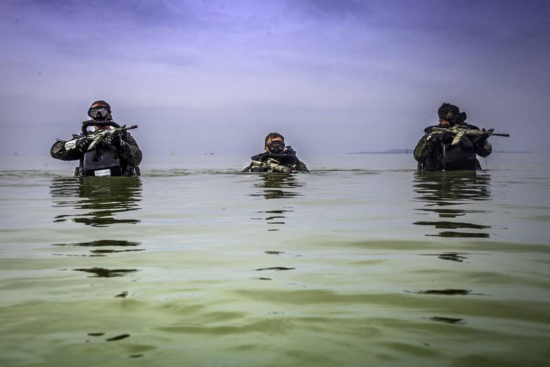 U.S. Marines patrol through water during a Marine Corps Combat Diving Supervisors Course on Camp Schwab, Okinawa, Japan, May 20, 2020.