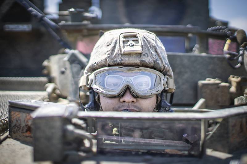 Lance Cpl. Tommy Vu, a light armored vehicle crewman, sits in an LAV during a field exercise at Marine Corps Base Camp Pendleton, Calif., May 28, 2020.