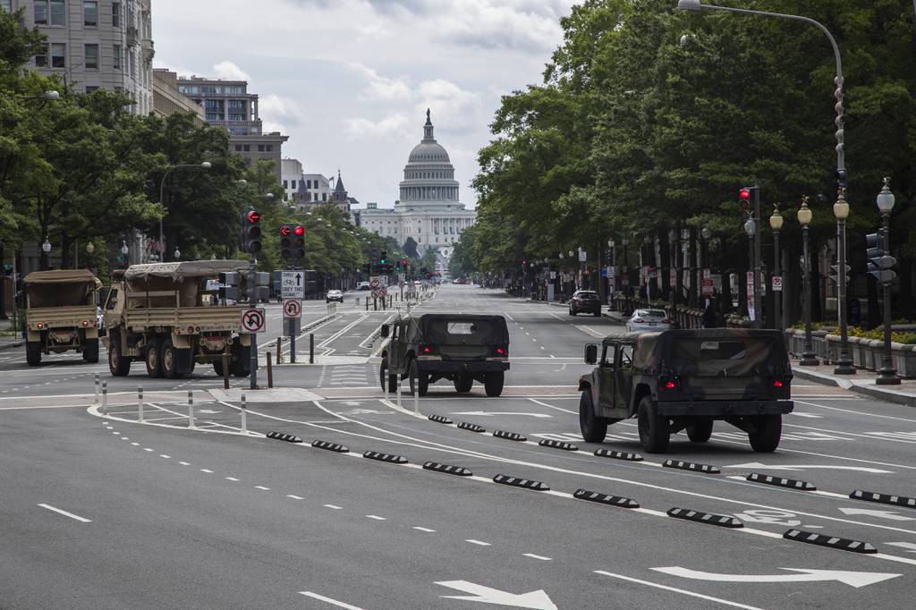 National Guard vehicles drive along Pennsylvania Avenue NW, as they prepare for protests and demonstrations, June 19, 2020, in Washington.