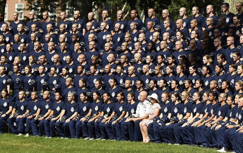 In a July 1, 2019, file photo, U.S. Coast Guard Academy Superintendent Rear Adm. William G. Kelly and his wife Angie pose with the Class of 2023 for their class photo on Day One of Swab Summer in New London, Conn
