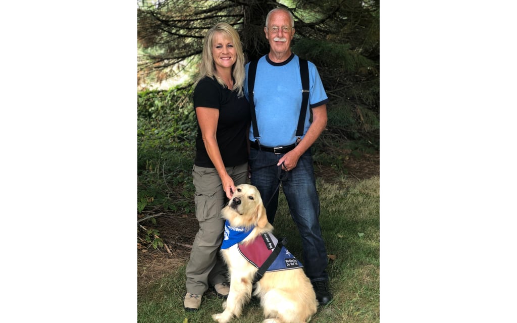 Northwest Battle Buddies CEO Shannon Walker poses with a veteran and his service dog.