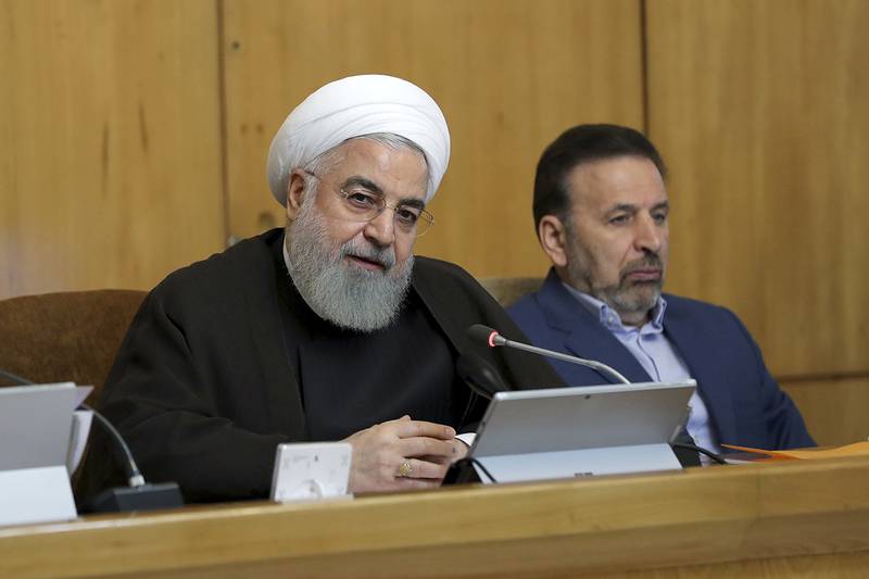 In this photo released by the official website of the office of the Iranian Presidency, President Hassan Rouhani speaks during a cabinet meeting, as President's chief of staff Mahmoud Vaezi sits at right, in Tehran, Iran, Wednesday, July 10, 2019.