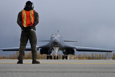 U.S. Air Force Technical Sgt. Rory Riggs marshals a B-1 Lancer at Eielson Air Force Base, Alaska, Sept. 10, 2020.