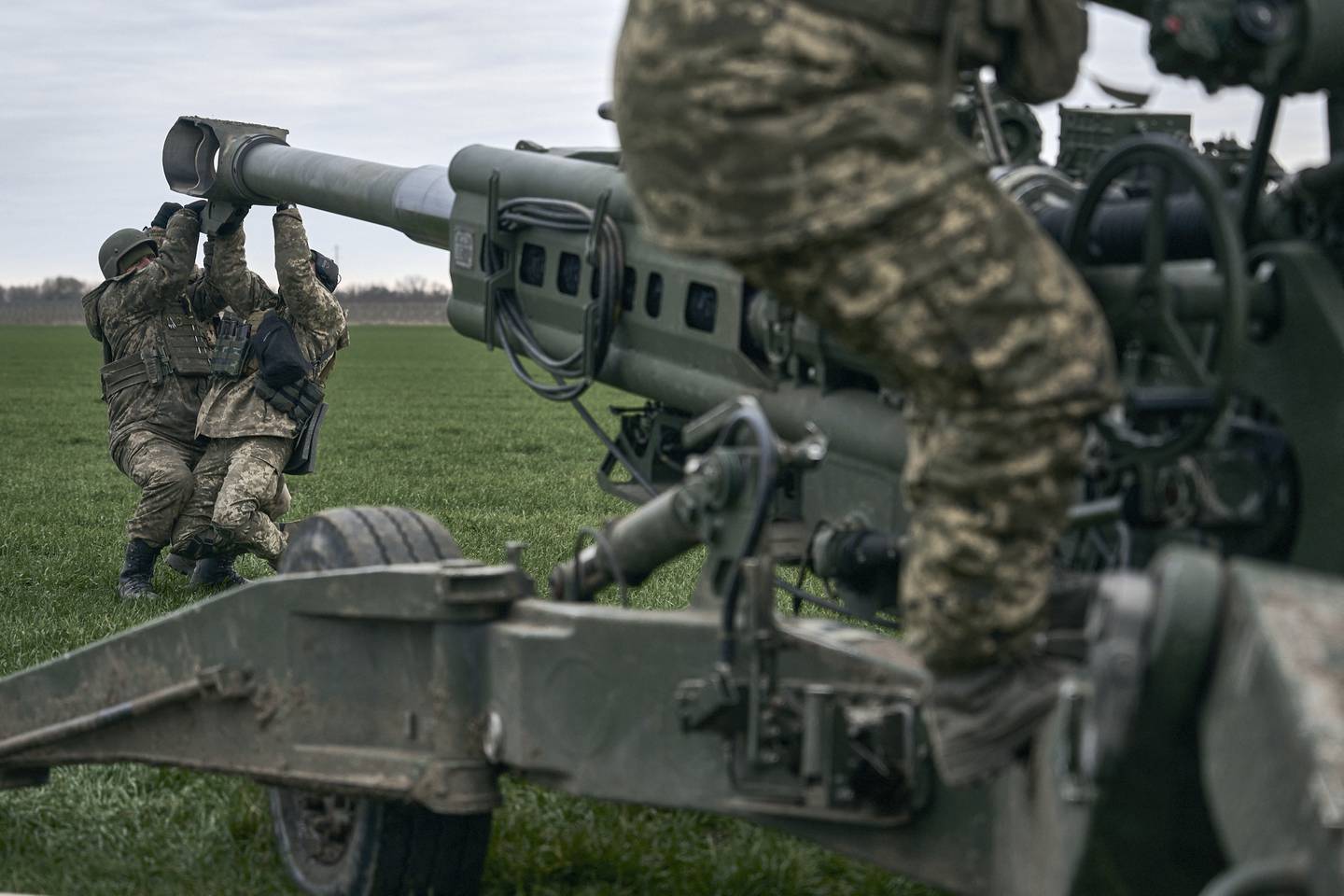 Ukrainian soldiers prepare a U.S.-supplied M777 howitzer to fire at Russian positions in Kherson region, Ukraine, Jan. 9, 2023.