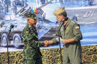 In this photo released by Royal Thai Army, Thailand Chief of Defence Forces General Chalermpol Srisawasdi, left, shakes hands with Commander of the United States Indo-Pacific Command Adm. John Aquilino, during opening ceremony of Cobra Gold 2023 in Rayong Province Thailand, Tuesday, Feb. 28, 2023.