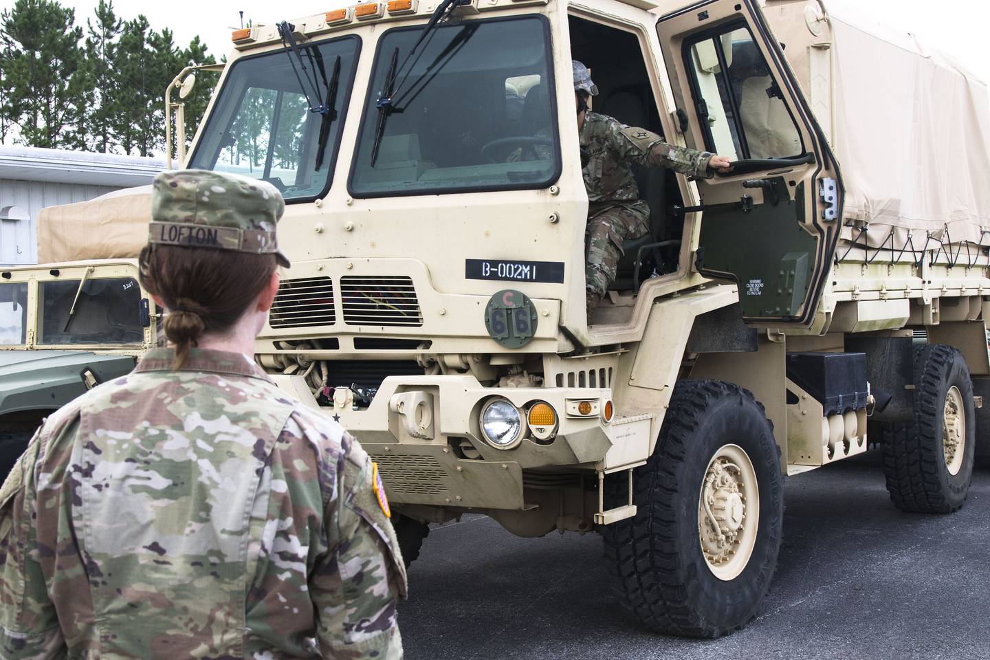 A Florida National Guard soldier works as a ground guide helping a driver during a convoy prep on Sept. 1.
