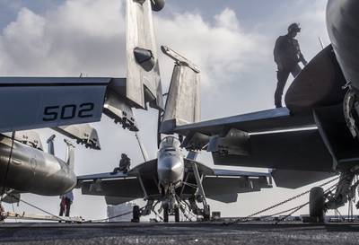 Sailors perform F/A-18 turnaround inspections Dec. 29, 2020, on the flight deck of the aircraft carrier USS Nimitz (CVN 68) in the Indian Ocean.