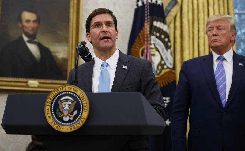 President Donald Trump looks to Secretary of Defense Mark Esper during a ceremony in the Oval Office at the White House in Washington, Tuesday, July 23, 2019.