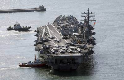 U.S. nuclear-powered aircraft carrier Ronald Reagan is escorted as it arrives in Busan, South Korea, Thursday, Oct. 12, 2023.