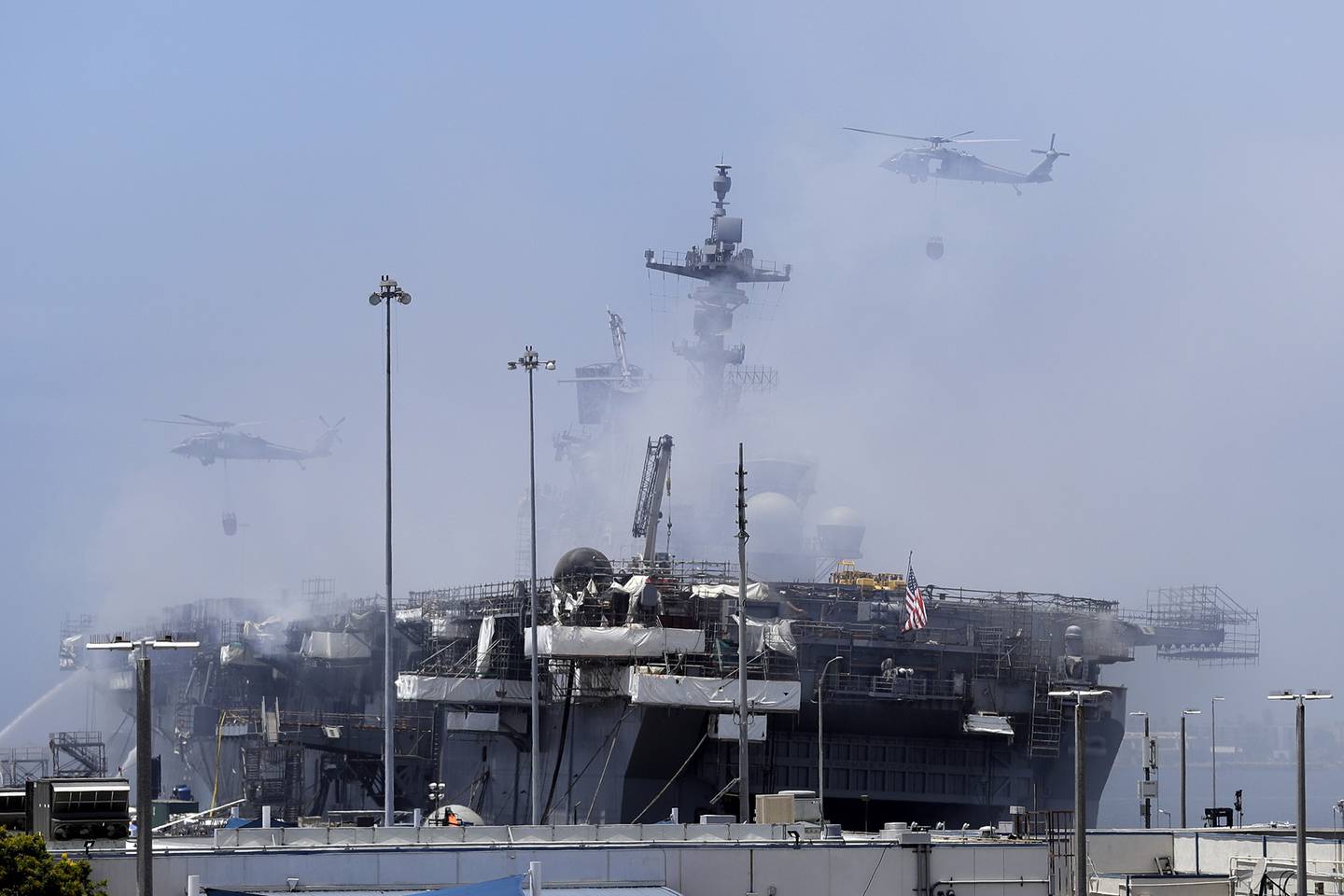 Helicopters approach the USS Bonhomme Richard as crews fight the fire on July 13, 2020, in San Diego.