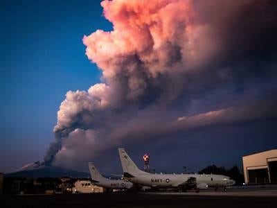 Mount Etna lets off some steam in the background of P-8A Poseidon maritime patrol aircraft Feb. 16, 2021, at Sigonella, Italy.