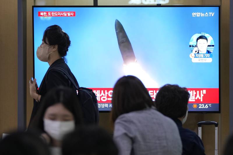 A TV screen shows a file image of a North Korean missile launch during a news program at the Seoul Railway Station in Seoul, South Korea, Wednesday, Sept. 28, 2022.