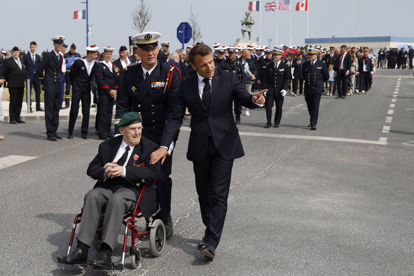 French President Emmanuel Macron speaks with Leon Gautier, a French WWII veteran of the Commando Kieffer, during a ceremony in tribute to the 177 French members of the "Commando Kieffer" Fusiliers Marins commando unit who took part in the Normandy landings, as part of the 79th anniversary of D-Day, in Colleville-Montgomery, Normandy, Tuesday, June 6, 2023.