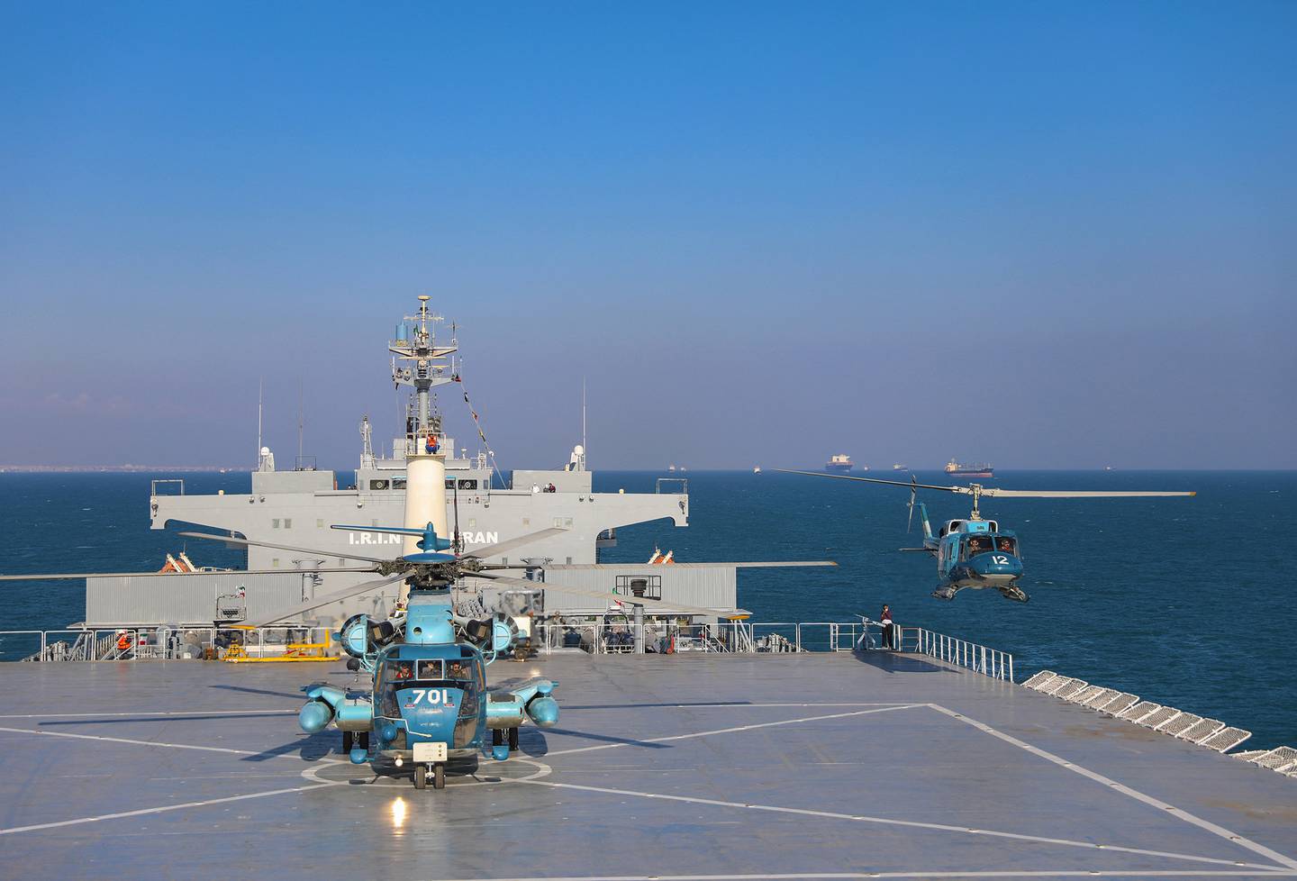 This image released Thursday, Jan. 14, 2021, by the Iranian Army shows helicopters and the Iranian-made Makran logistics vessel during a naval drill.