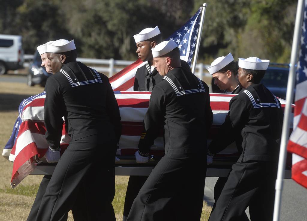 In this Dec. 16, 2019 file photo, sailors carry the casket of Cameron Walters at Oak Hill Cemetery in Richmond Hill, Ga.