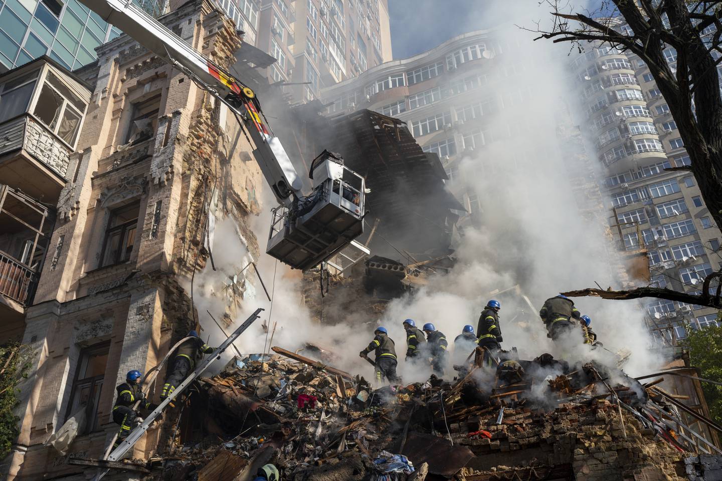 Firefighters work after a drone attack on buildings in Kyiv, Ukraine, Monday, Oct. 17, 2022.