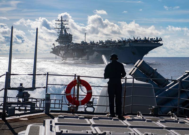 Seaman Marcus White stands watch as aft lookout aboard the Ticonderoga-class guided-missile cruiser USS Chancellorsville (CG 62) on June 30, 2019, during a replenishment-at-sea with the Nimitz-class aircraft carrier USS Ronald Reagan (CVN 76) in the Philippine Sea.