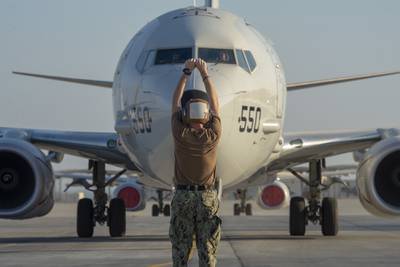 Culinary Specialist Seaman Tyler Stender directs a P-8A Poseidon maritime patrol and reconnaissance aircraft on Nov. 24, 2020, in the U.S. 5th Fleet area of operations.