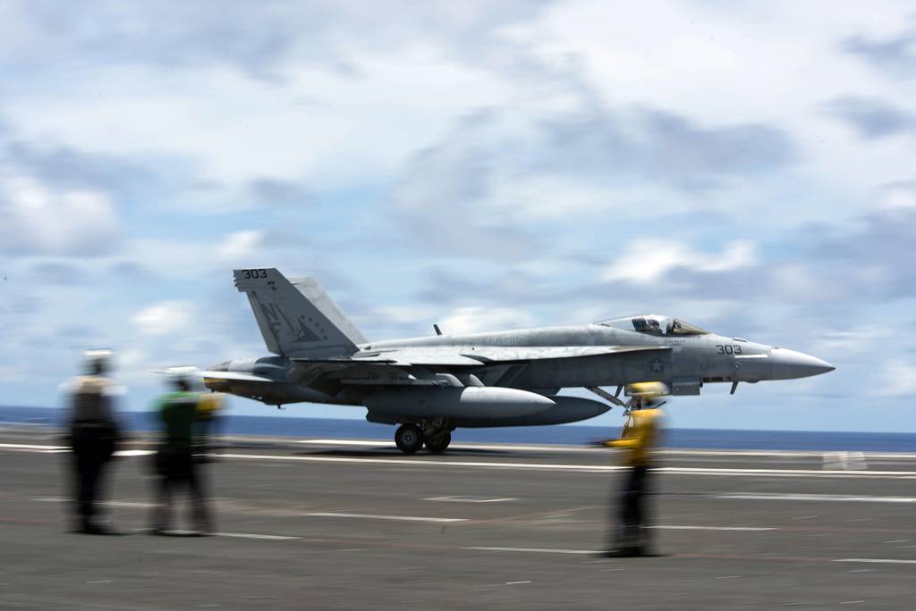 An F/A-18E Super Hornet practices a touch-and-go maneuver on the flight deck of the aircraft carrier USS Ronald Reagan (CVN 76) on June 10, 2020, in the Philippine Sea.