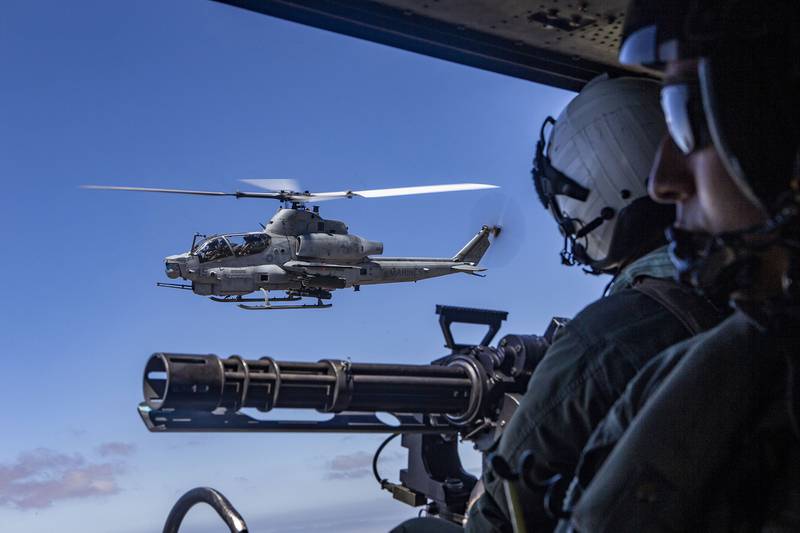 An AH-1Z Viper helicopter and a UH-1Y Venom helicopter fly alongside each other during an aerial gunnery range at Naval Air Facility El Centro, Calif., July 16, 2020.