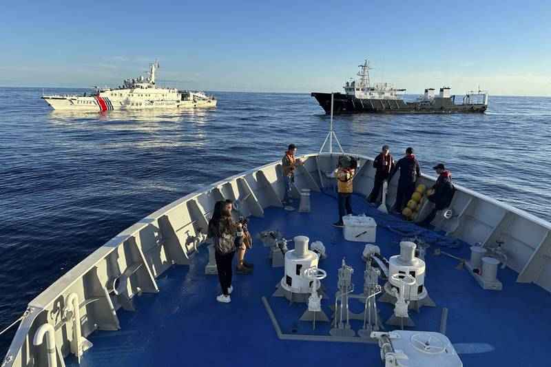 Chinese coast guard and suspected Chinese militia ship block the Philippine coast guard ship BRP Cabra as they approach Second Thomas Shoal, locally known as Ayungin Shoal, during a resupply mission at the disputed South China Sea on Friday Nov. 10, 2023.