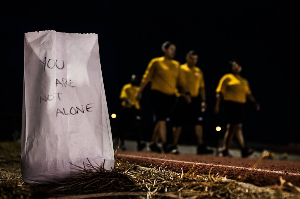 Sailors assigned to the Nimitz-class aircraft carrier USS Abraham Lincoln (CVN72) participate in an overnight “Out of the Darkness Walk,” to recognize Suicide Prevention Awareness Month at Huntington Hall in Newport News, Va., in 2015.