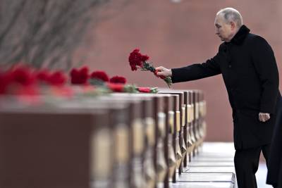 Russian President Vladimir Putin attends a wreath-laying ceremony at the Tomb of the Unknown Soldier, near the Kremlin Wall during the national celebrations of the "Defender of the Fatherland Day" in Moscow, Russia, Thursday, Feb. 23, 2023.
