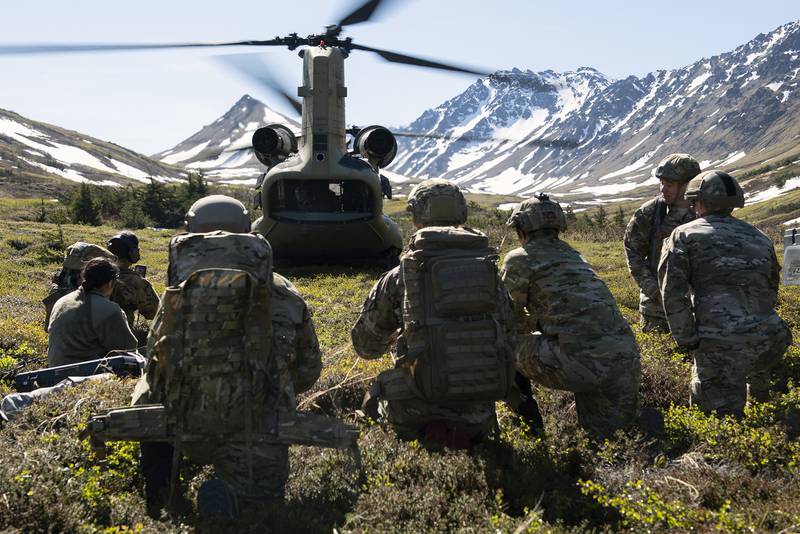 Battlefield airmen with the 3rd Air Support Operations Squadron and Alaska Army National Guard soldiers watch an Army CH-47 Chinook helicopter as it prepares to depart Geronimo Drop Zone during airborne training at Joint Base Elmendorf-Richardson, Alaska