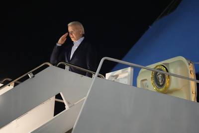 President Joe Biden salutes as he boards Air Force One at Andrews Air Force Base, Md., on Tuesday, Dec. 27, 2022.