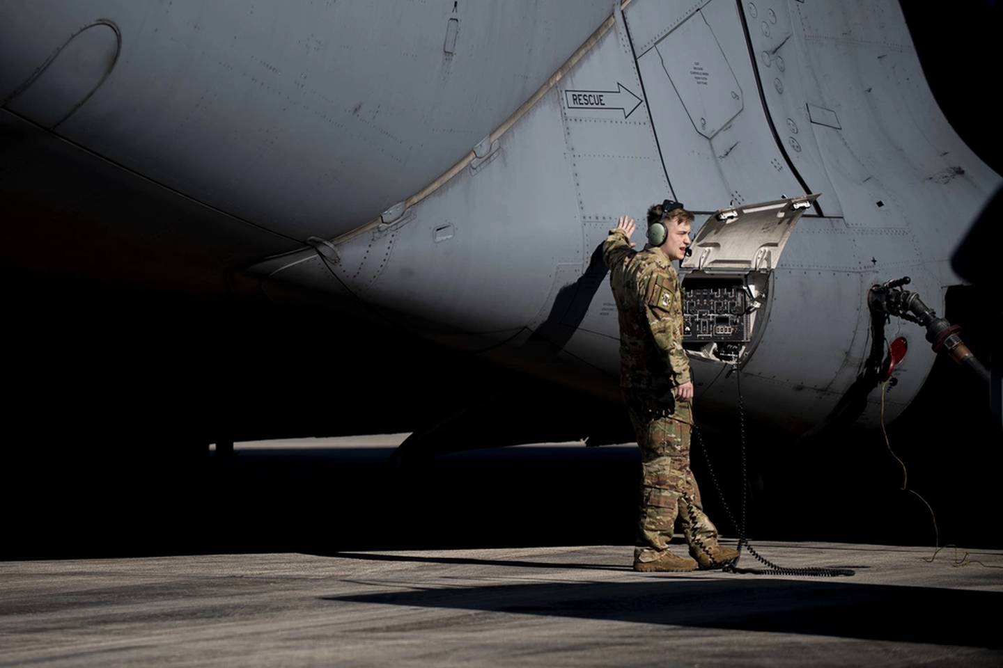 Then-Senior Airman Duncan Copley, a C-17 Globemaster III loadmaster from the 3rd Airlift Squadron at Dover Air Force Base, Delaware, transfers fuel from a C-17 to an R-11 fuel truck during Exercise Razor Talon 21-1 at Marine Corps Air Station Cherry Point, North Carolina, Dec. 2, 2020. The transferred fuel was later used to refuel four F-15E Strike Eagles. (Senior Airman Jacob Derry/Air Force)