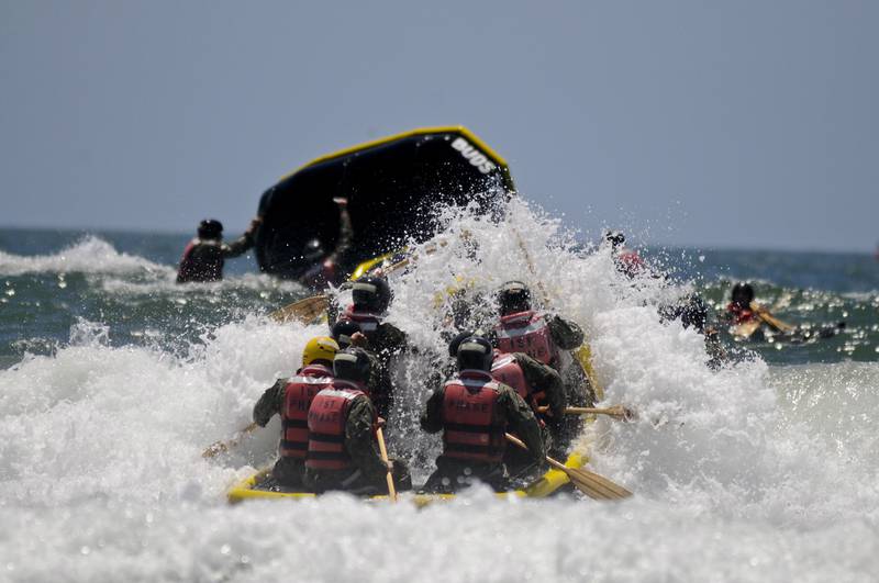 Basic Underwater Demolition/SEAL (BUD/S) candidates attempt to pass the surf zone in an inflatable boat during training at Naval Special Warfare Center in Coronado, Calif., May 20, 2020.
