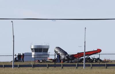 A damaged plane sits at the Dallas Executive Airport in Dallas after two historic military planes collided and crashed on Saturday, Nov. 12, 2022.