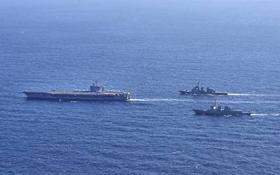 In this photo provided by South Korea's Joint Chiefs of Staff, the aircraft carrier USS Carl Vinson, left, sails with South Korean Navy's Aegis destroyer King Sejong the Great and Japan's Maritime Self-Defense Force Aegis destroyer Kongou in the international waters of the southern coast of Korean peninsular during a recent joint drill in 2024.