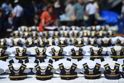 The new hats and shoulder bars for the graduates sit on a table before the start of the Coast Guard Academy's 141st Commencement Exercises, May 18, 2022, in New London, Conn.