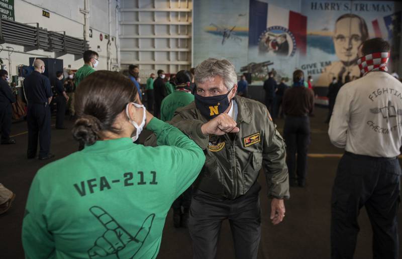 Secretary of the Navy Kenneth J. Braithwaite elbow-bumps a sailor following an all-hands call in the hangar bay of the Nimitz-class aircraft carrier USS Harry S. Truman (CVN 75) on June 4, 2020, in the Atlantic Ocean, marking his first visit as Navy secretary to a ship underway.