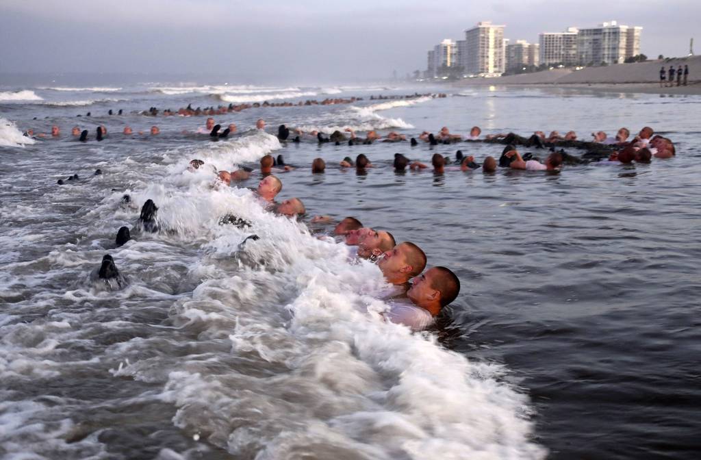 U.S. Navy SEAL candidates, participate in "surf immersion" during Basic Underwater Demolition/SEAL (BUD/S) training at the Naval Special Warfare (NSW) Center in Coronado, Calif., on May 4, 2020.