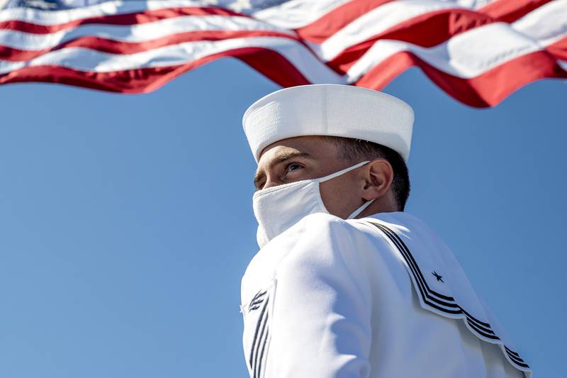 Information Systems Technician Seaman Russell Brown prepares to lower the American flag aboard the Blue Ridge-class command and control ship USS Mount Whitney (LCC 20) in Gaeta, Italy, July, 20, 2020.