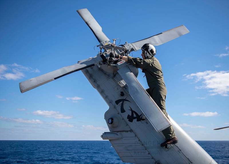Lt. Austin Gallegos verifies tail rotor integrity on a MH-60R Sea Hawk on July 19, 2019, aboard the Ticonderoga-class guided-missile cruiser USS Chancellorsville (CG 62) in the Coral Sea.
