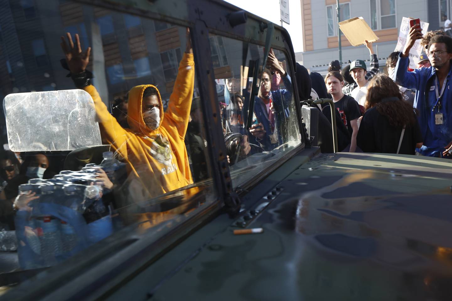 Protesters stand near a Minnesota National Guard vehicle Friday, May 29, 2020, in Minneapolis. Protests continued following the death of George Floyd, who died after being restrained by Minneapolis police officers on Memorial Day.