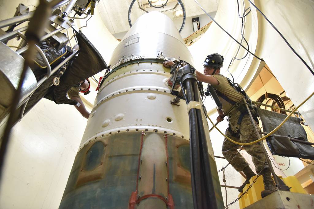 In this image provided by the U.S. Air Force, Airman 1st Class Jackson Ligon, left, and Senior Airman Jonathan Marinaccio, 341st Missile Maintenance Squadron technicians, connect a re-entry system to a spacer on an intercontinental ballistic missile during a Simulated Electronic Launch-Minuteman test Sept. 22, 2020, at a launch facility near Malmstrom Air Force Base in Great Falls, Mont.