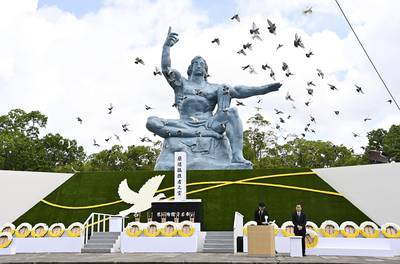 Doves fly over the Statue of Peace during a ceremony at Nagasaki Peace Park in Nagasaki, southern Japan on Aug. 9, 2020, to mark the 75th anniversary of the world's second atomic bomb attack.