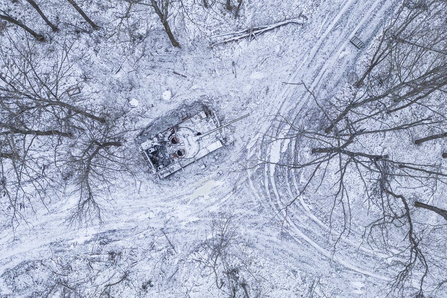 A destroyed Russian tank covered by snow stands in a forest in the Kharkiv region, Ukraine, Saturday, Jan. 14, 2023.